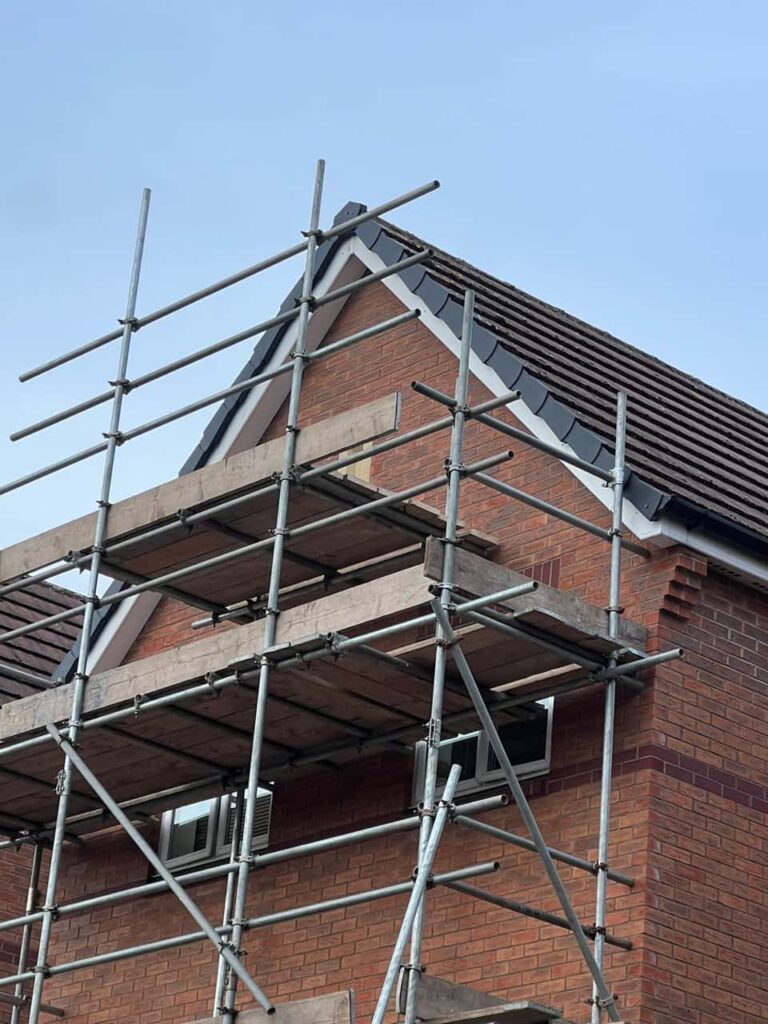 This is a photo of a roof which has just been repaired. There is a scaffold located at the gable end for access onto the roof. Works carried out by Haddenham Roofing Repairs